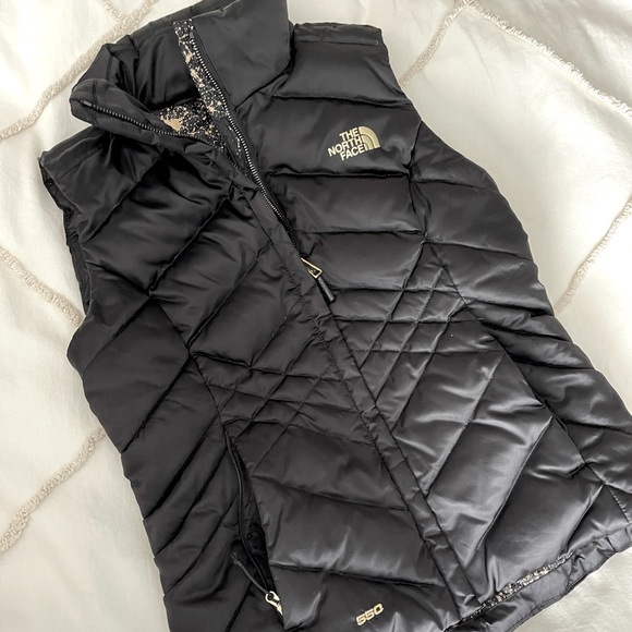 black and gold north face vest